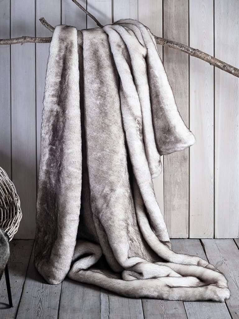 Faux chinchilla blanket styled with natural elements.