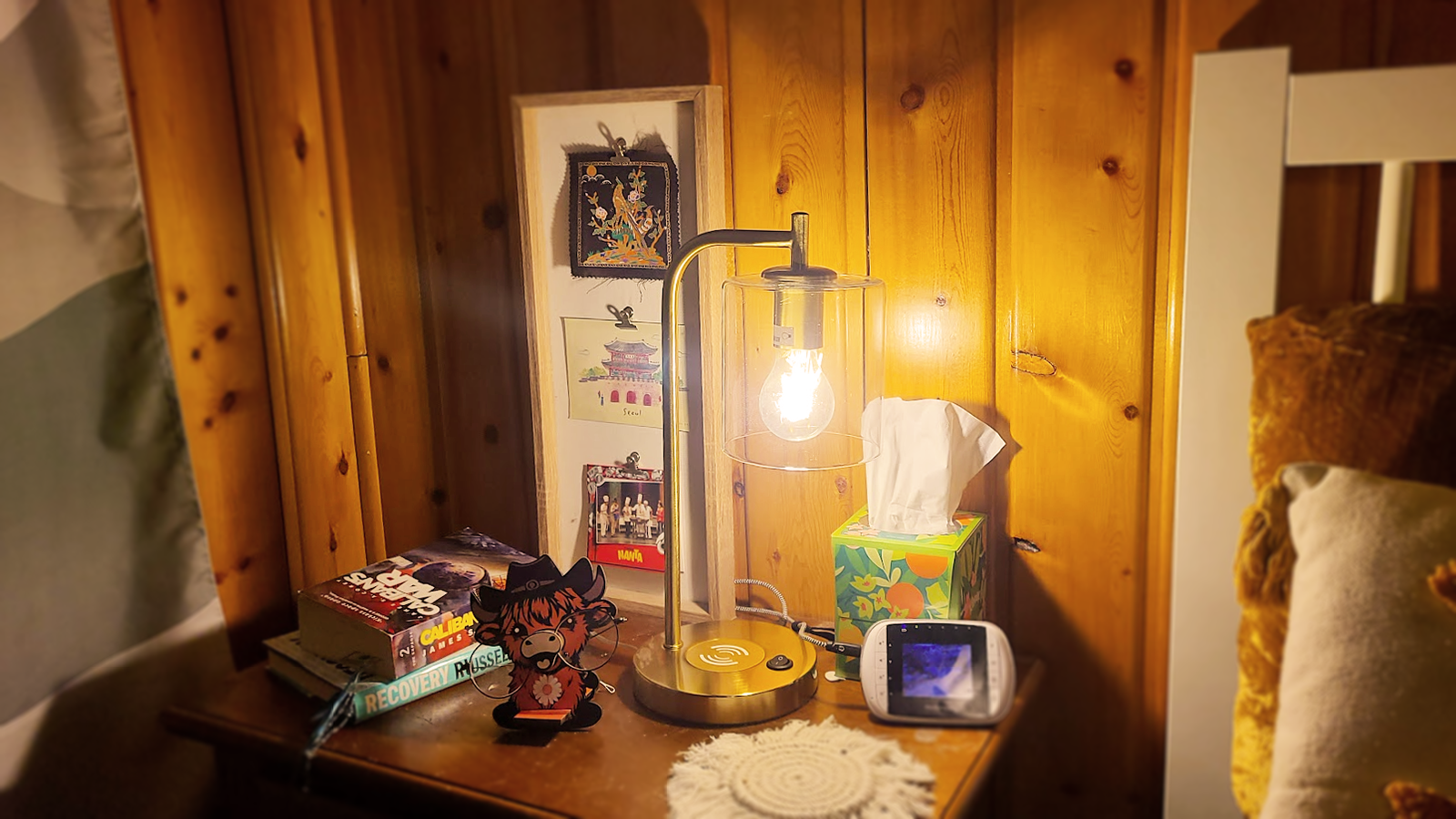 A cozy bedside table with a bronze lamp