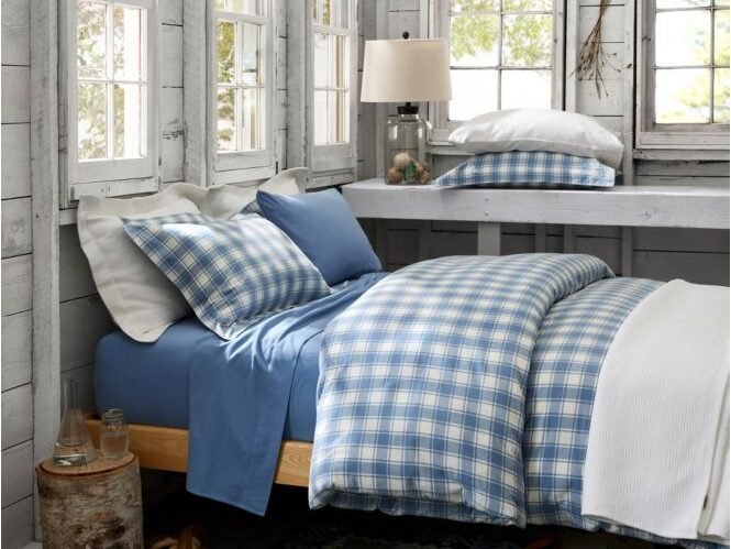 Flannel sheets of various patterns and colors on a freshly made bed.